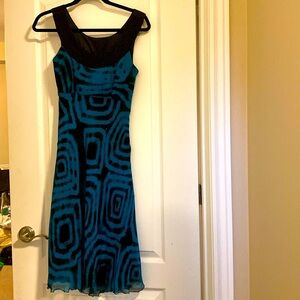 100% silk dress size S with black beaded detail at neckline.